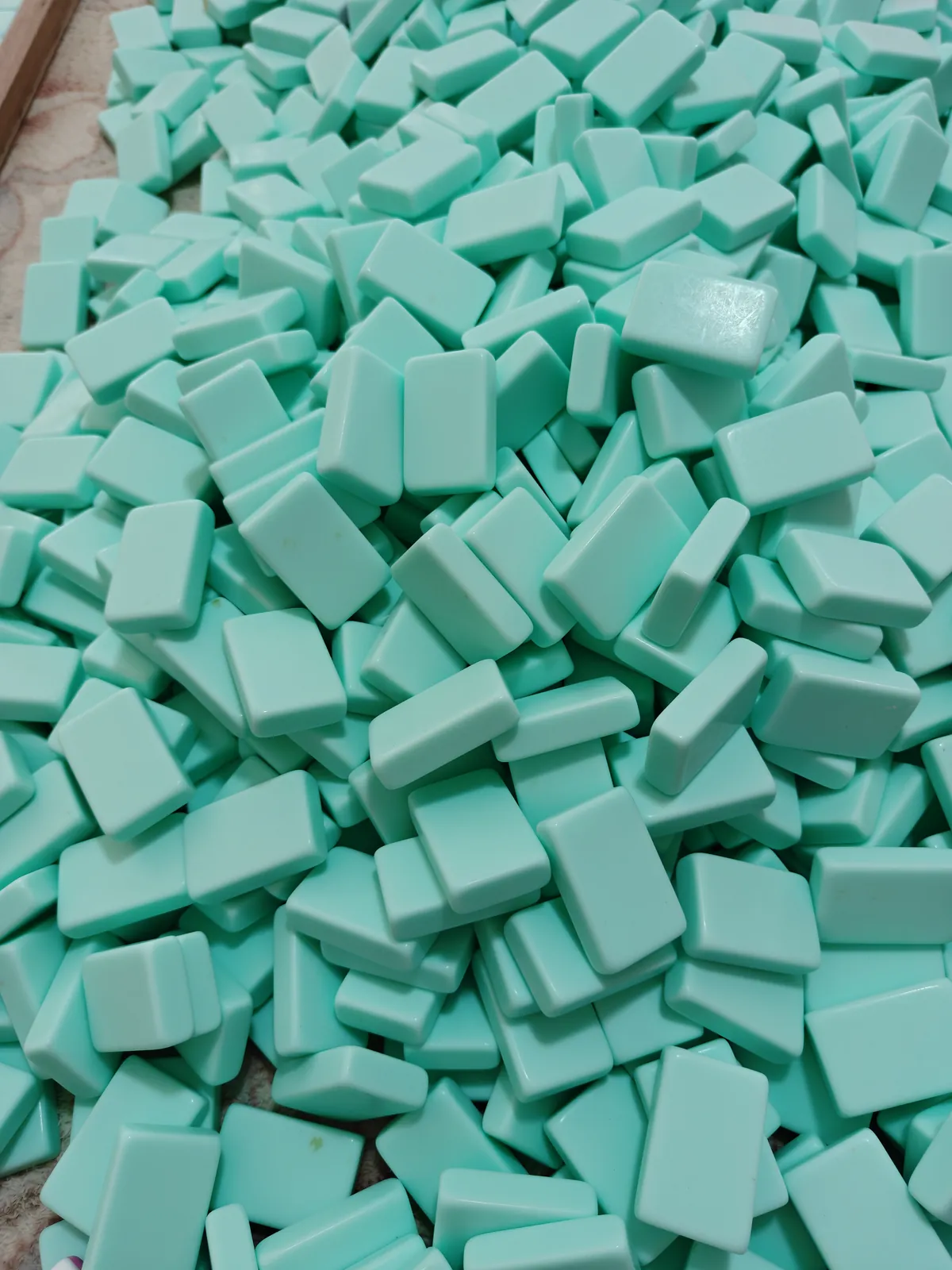 Mint green acrylic Mahjong tile blanks held as stock