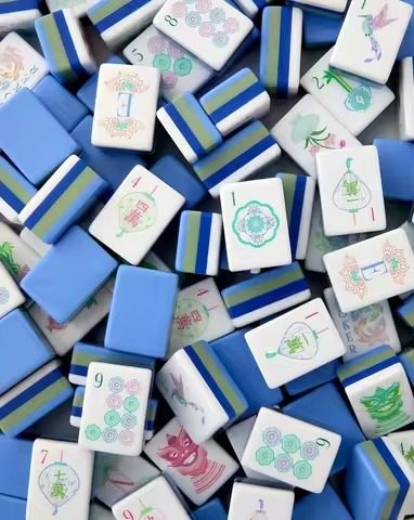 Glossy acrylic American Mahjong tiles arranged on a rack
