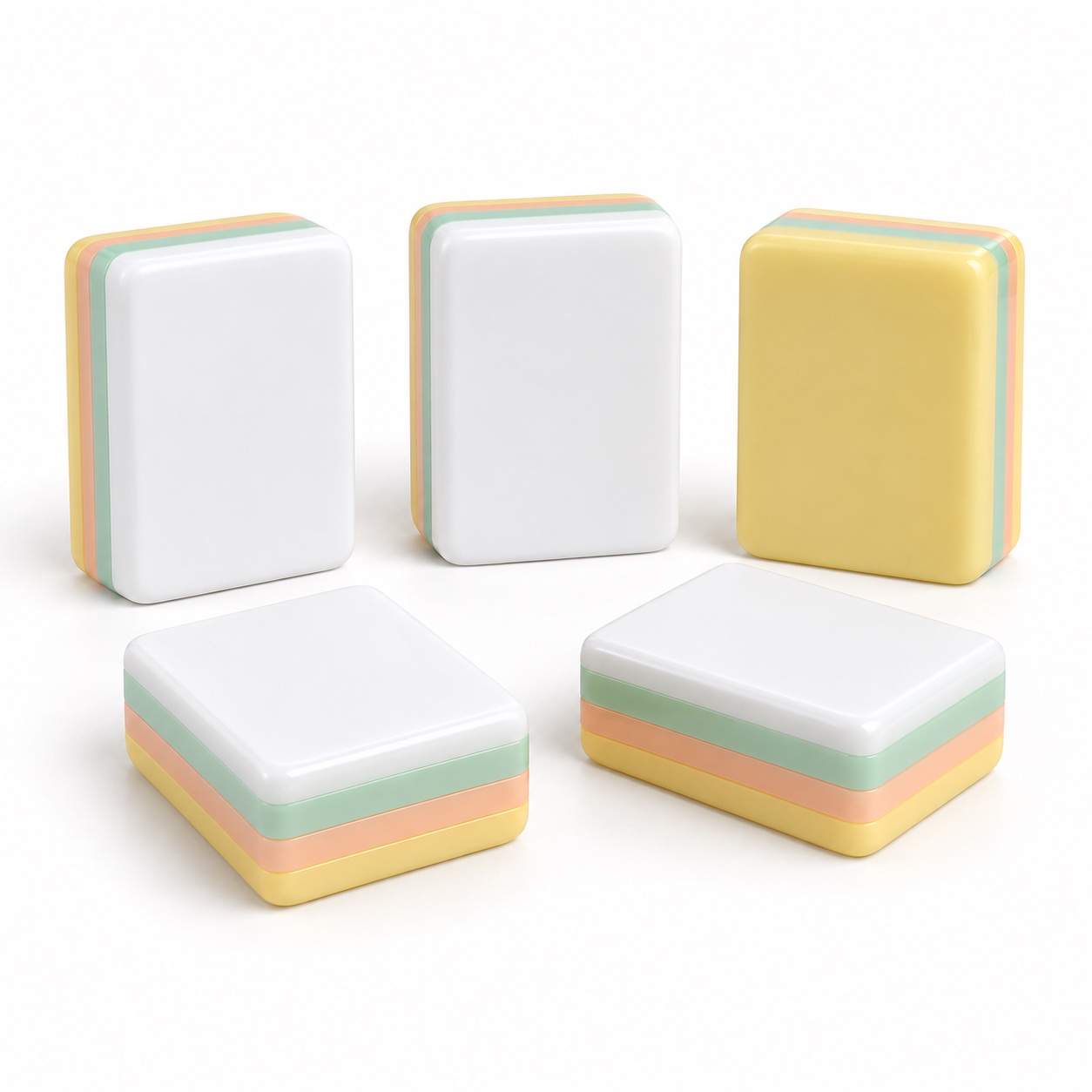 Yellow and white layered acrylic Mahjong tiles arranged on a plain background